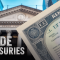 A close-up of a U.S. Treasury certificate overlaid on a background of a classical government-style building, with the words “Trade Treasuries” displayed in bold letters.